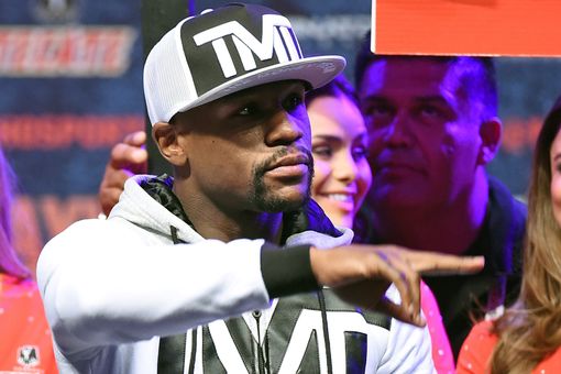WBC/WBA welterweight champion Floyd Mayweather Jr. gestures as he arrives at MGM Grand Garden Arena on April 28, 2015 in Las Vegas, Nevada.